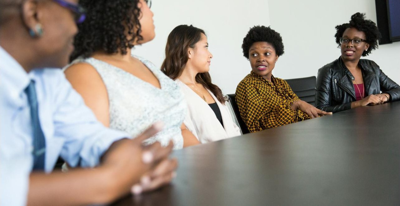Colleagues in conversation around a boardroom table